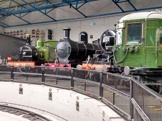 A collection of steam trains around the Great Hall turntable at the National Railway Museum